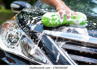 Closeup Man Washing New Black Shiny Car, Soapy Sponge, Sunny Day, Summer, Front Grille, Pampering Car, Automobile Maintenance, Shiny, Sparkling, Foam, Headlight, Water, Hood, Suds, Bubbling