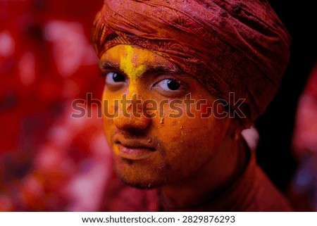 Closeup of a man whose face was covered with red powder