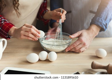 Closeup Of Man And Woman Hands Whisking Eggs And Baking Pie In Loft Kitchen. Unrecognizable Couple Cooking Dough Together, Copy Space