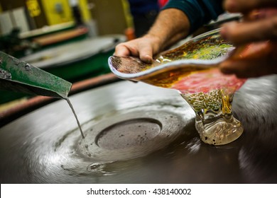 Closeup Of Man Working A Glass Blown Vase On Spinning Silica Sanding Disk