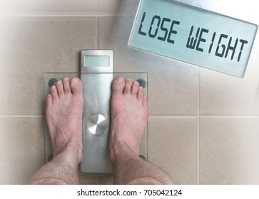 Closeup Of Man's Feet On Weight Scale - Lose Weight