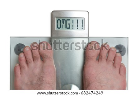Closeup of man's feet on weight scale - OMG