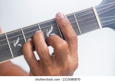 Closeup man's finger playing guitar chords, Chord B minor (Bm)