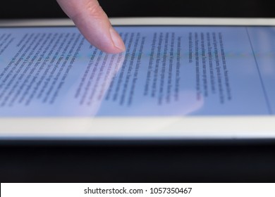 closeup man's finger scroll touching tablet touchscreen