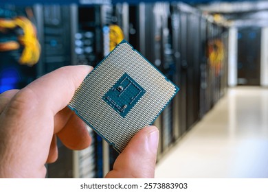 Close-up of a man's hand holding a CPU in a server room