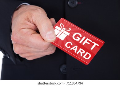 Close-up Of Man's Hand Holding Gift Card