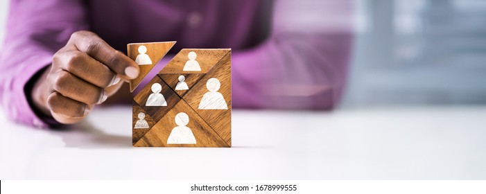 Close-up Of Man's Hand Holding A Missing Piece In A Square Tangram Puzzle - Powered by Shutterstock