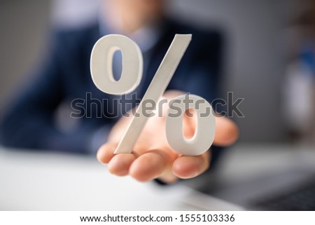 Close-up Of Man's Hand Holding Percentage Symbol