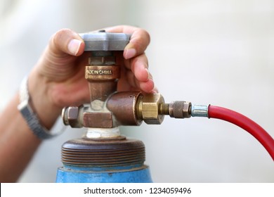 Closeup Man's Hand Operating Valve Of Gas Cylinder For Welding