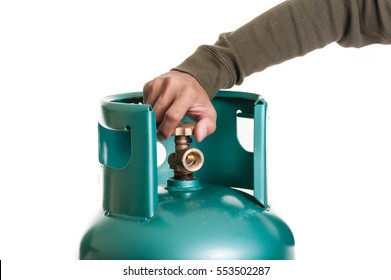 Closeup Man's Hand Operating Valve Of LPG Cylinder For Cooking