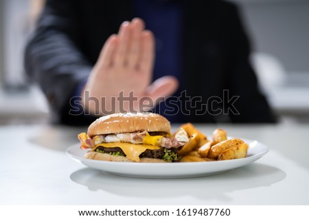Close-up Of A Man's Hand Refusing To Eat Fest Food Burger
