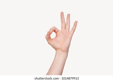 Closeup of man's hand showing OK sign isolated on white - Shutterstock ID 1014879913