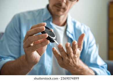 Close-up Of A Man's Hand Testing High Blood Sugar With Glucometer