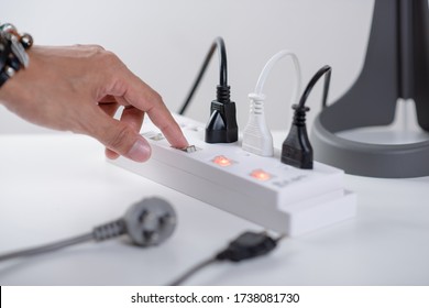 Closeup Of A Mans Hand Turn Off The Switch On Power Strip.