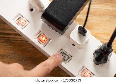 Closeup Of A Mans Hand Turn Off The Switch On Power Strip.