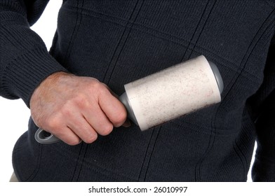 Close-up Of Man's Hand Using Lint Brush On Gray Sweater