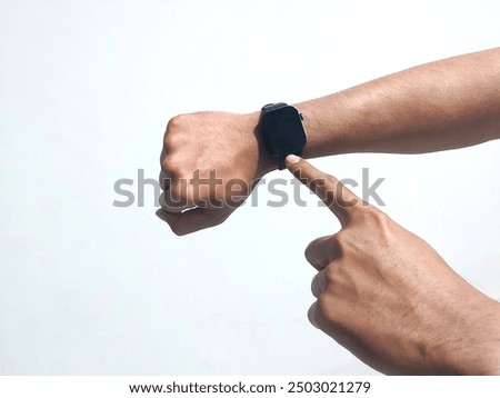 Close-up of a man's hand using a smart watch on a white background. Cropped hand pointing to an isolated watch. The concept of using technology in everyday life