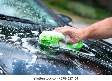 Closeup Man's Hand Washing New Black Car With Sponge, Soap Suds, Sunny Day, Care Care, Rubbing, Cleaning Car, Pampering Car, Automobile Maintenance, Shiny, Sparkling, Foaming, Foam, Dirty Car, Water