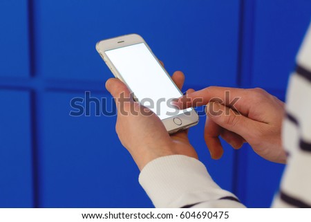 Closeup of man's hands holding and using modern smart phone with empty screen for your content or text message