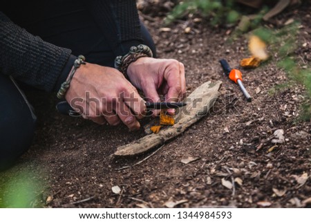 Closeup of man's hands preparing a fire in nature with tinder fungus fomes fomentarius