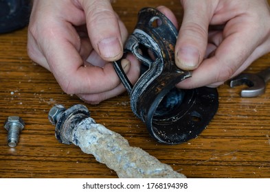 Close-up Of A Man's Hands Showing A Torn Rubber Gasket For A Water Heater. Repair And Maintenance Services For Home Appliances. Eye Level Shooting. Selective Focus.