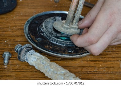 Close-up Of A Man's Hands Showing A Torn Rubber Gasket For A Water Heater. Repair And Maintenance Services For Home Appliances. Eye Level Shooting. Selective Focus.