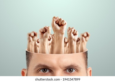 Close-up Of A Man's Head Instead Of A Brain, Fists Raised Up. The Concept Of Fighting For Their Rights, Labor Movement, Electoral Movement. Creative Background