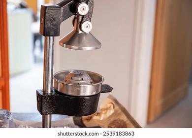 Close-up of a manual metal citrus juicer in a kitchen. Perfect for fresh juice preparation and healthy living concepts. - Powered by Shutterstock