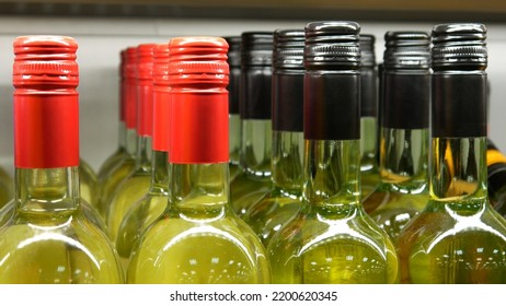 Close-up Of Many Beautiful Glass Bottles Of White Wine Or Vermouth