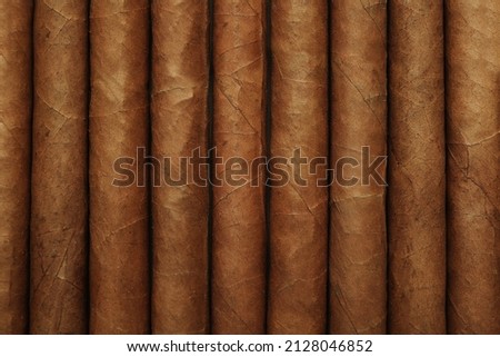 Closeup of many cigars as background, top view
