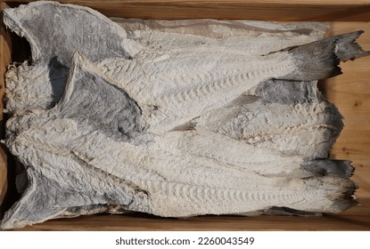 A close-up of many dried and salted cod fish, from which a Portuguese culinary specialty is prepared ( Bacalhau )