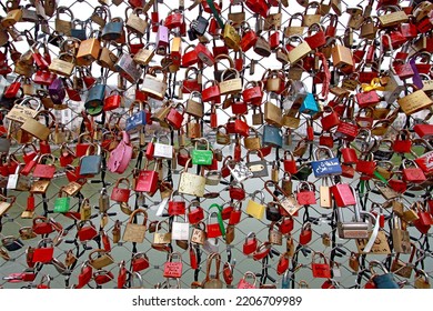 A Closeup Of Many Locks On An Iron Fence