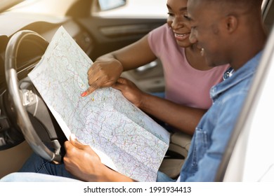 Closeup Of Map In Smiling African American Couple Hands, Having Weekend Car Trip Together. Happy Black Family Husband And Wife Tracking Their Journey, Going Vacation By Comfortable Auto