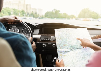 Closeup Of Map In Unrecognizable African American Lady Hands, Tracking Car Trip, Showing Her Boyfriend Way. Black Family Husband And Wife Having Journey, Going Vacation By Comfortable Auto