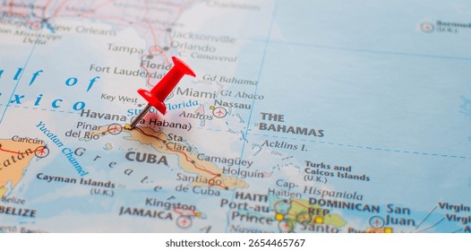 Close-up map view of Cuba with a red pushpin on Havana. The Bahamas and parts of the southeastern United States appear in the background.
