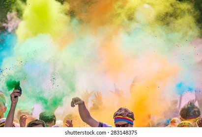 Close-up of marathon, people covered with colored powder.