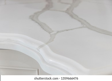 Closeup Of A Marble Looking Quartz Countertop Edge Profile With Beautiful Natural Stone Veining.