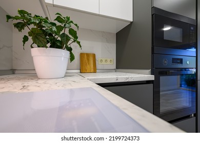 Closeup To Marble Worktop Of Modern Dark Grey And White Kitchen