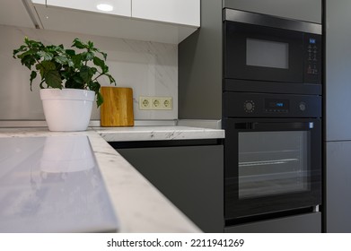 Closeup To Marble Worktop Of Modern Dark Grey And White Kitchen