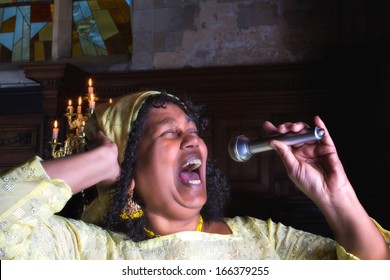 Closeup of a mature gospel or soul singer in a dark church