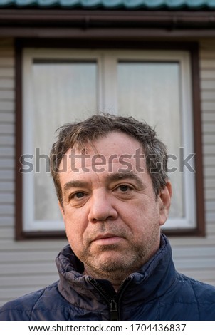 Close-up of a mature man near the house