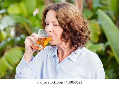 Close-up Of Mature Woman Drinking Herbal Tea