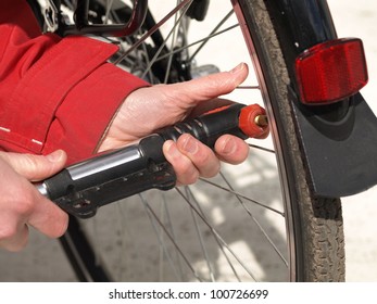 Closeup of mechanic pumping a bicycle tire - Powered by Shutterstock