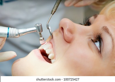 close-up medical dentist procedure of teeth polishing with cleaning from dental deposit and odontolith - Powered by Shutterstock