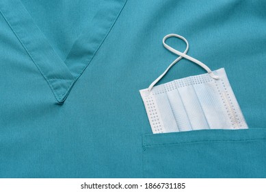 Closeup Of A Medical Scrubs Top With A Surgical Mask In The Pocket. 