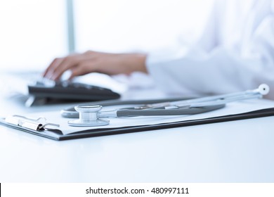 Close-up of a medical worker typing on laptop