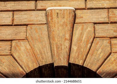 Close-up of a medieval arch made of bricks with keystone with the rusticated wall or ashlar (Bugnato in Italian), in Treviso downtown, Veneto, Italy, Europe.
