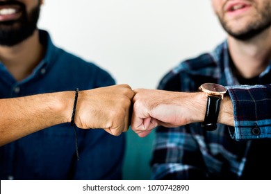 Closeup of men fist bumping - Shutterstock ID 1070742890