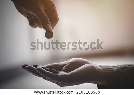 Closeup of men giving money to poor or homeless people poverty beggar in the city sitting on the streets with a sign for help Foto stock © 