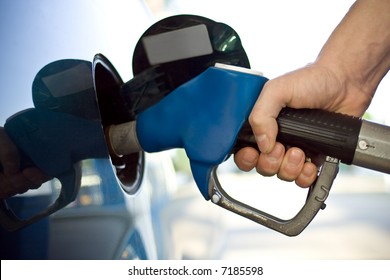 Close-up Of A Mens Hand Refilling The Car With A Gas Pump